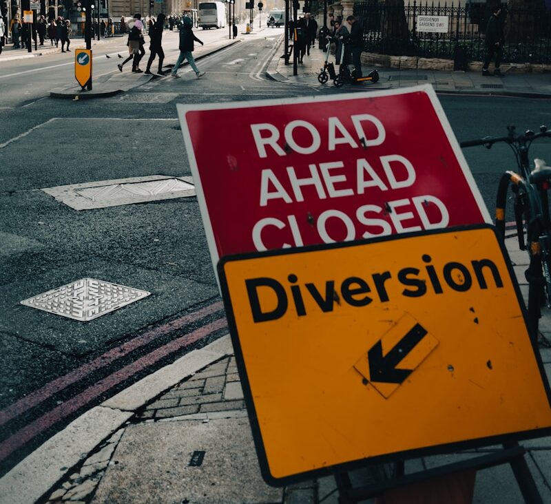 a road ahead closed sign on the side of the road